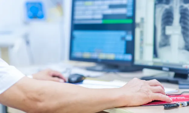 medical tech working on computer